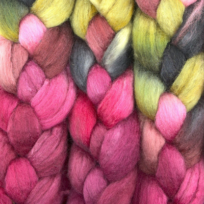 Hand painted BFL tussah silk combed top, hot pink, cranberry and butter yellow, braid closeup